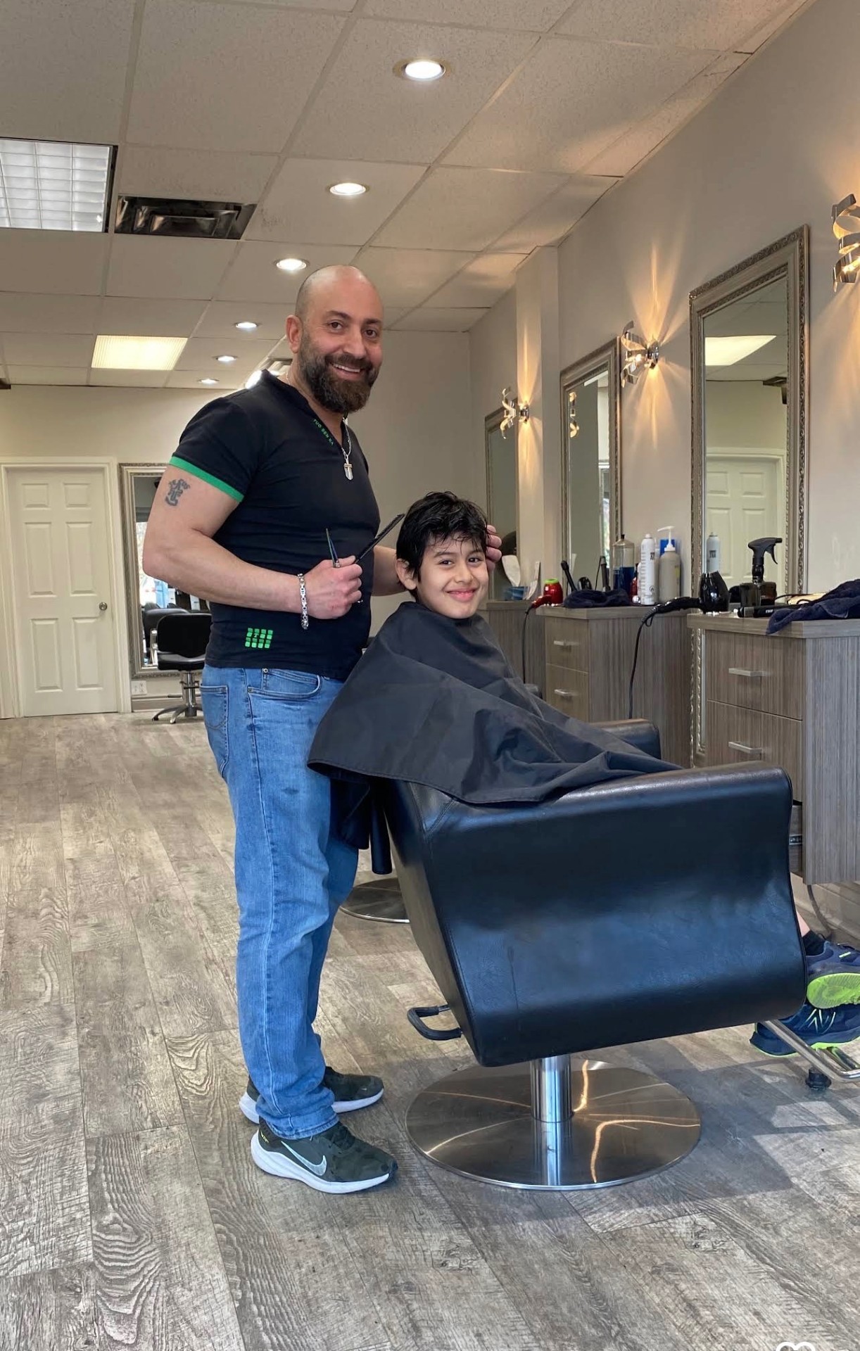 Jimmy cutting a young client's hair at his Toronto salon